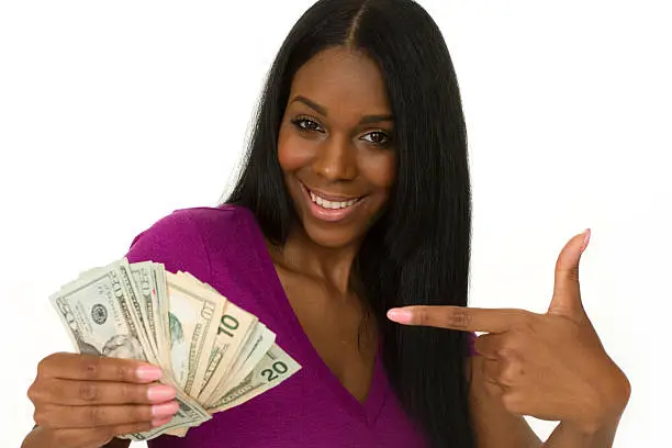 young adult holding a bundle of cash on white background