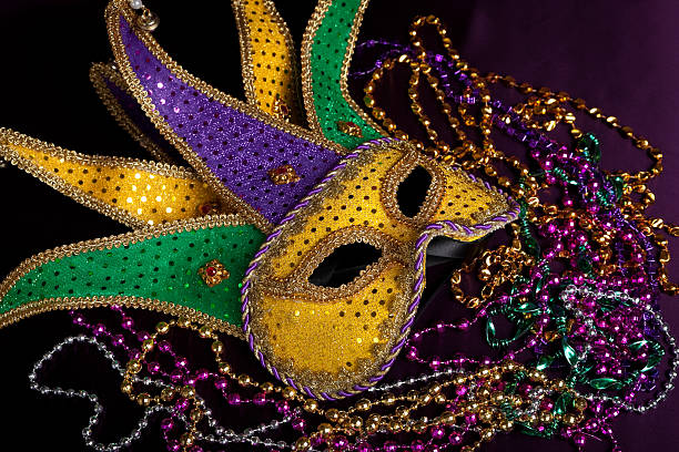 istock Mardi gras jester's mask with beads on a black background 160525740