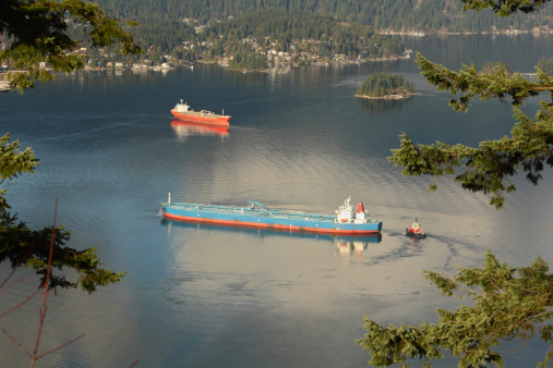 Oil tankers maneuver  in Burrard Inlet. Vancouver, British Columbia, Canada.
