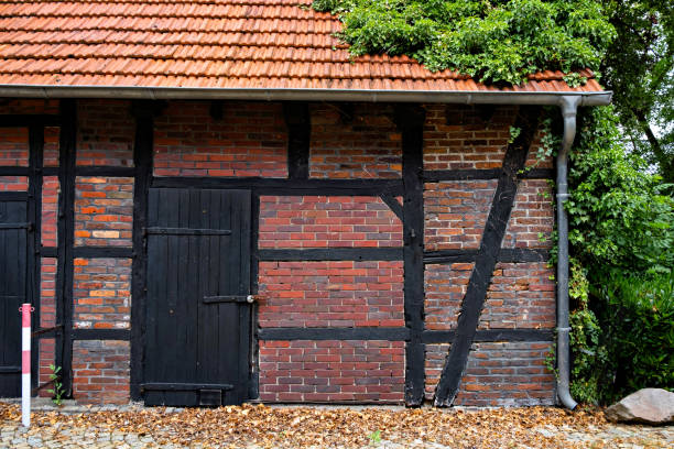 istock Red brick building with black door in Germany 1605258499