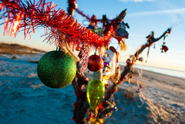 Christmas Ornaments on a Beach at Sunrise. stock photo