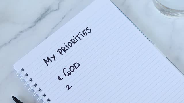 God first, top priorities list, handwritten text on spiral notebook paper