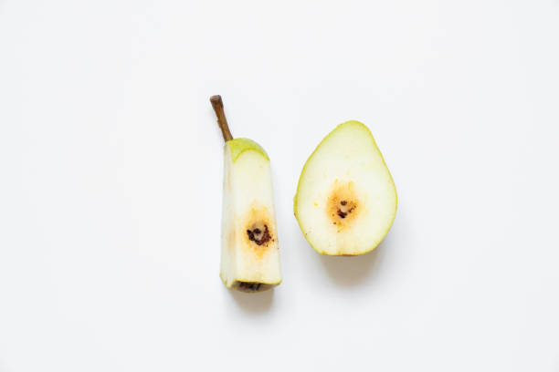 Sliced pear with a worm on a white background stock photo