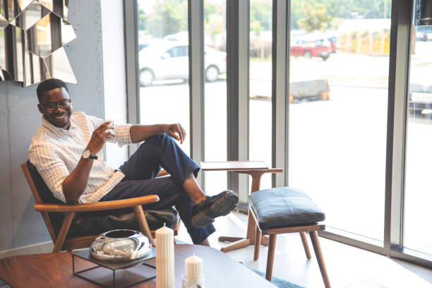 istock A man sits in modern apartment with drink 1605279857