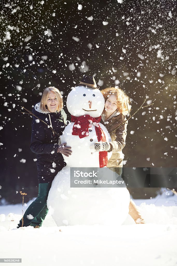 Zwei junge Frauen, die sich umarmen Schneemann - Lizenzfrei Aktivitäten und Sport Stock-Foto