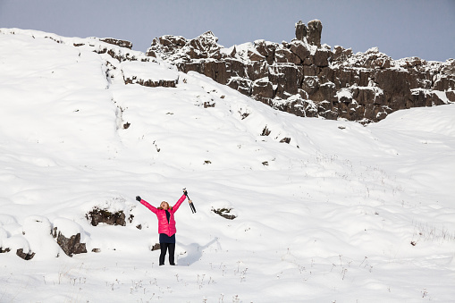 A young woman posing in Thingvellir National Park or better known as Iceland pingvellir National Park during winter