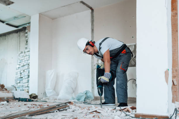 istock Worker in safety helmet engaged in apartment renovation 1605284805