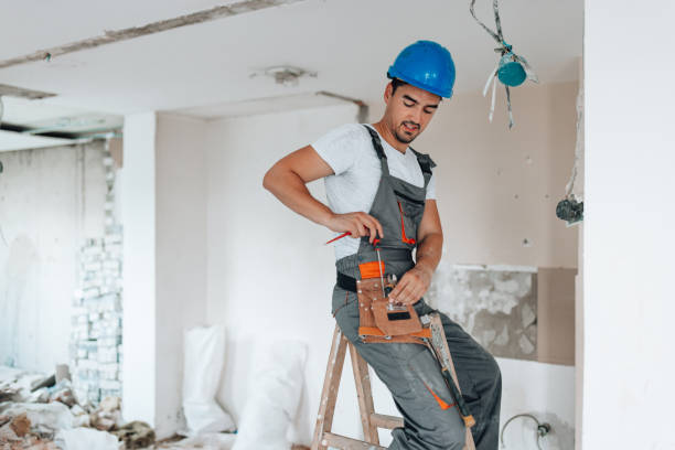 istock Apartment renovation underway with helmet-wearing worker 1605285346