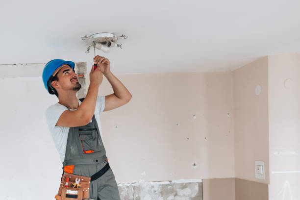 istock Construction worker plays a role in improving the apartment ceiling during renovation 1605285384