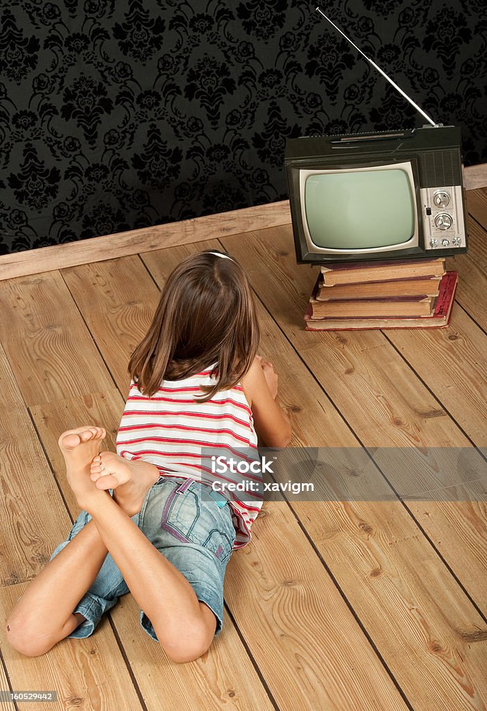 little girl watching tv little girl watching old retro tv Beauty In Nature Stock Photo