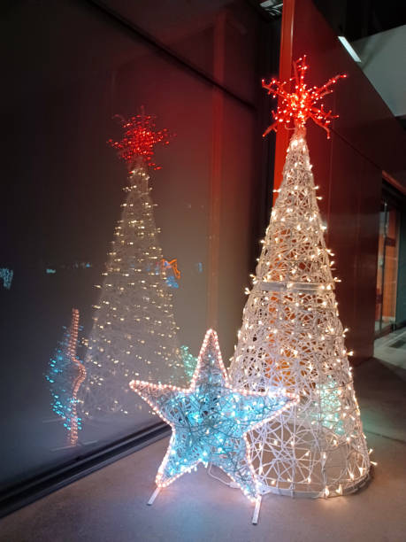 istock Christmas decoration outdoors. White tree with colorful stars 1605309855