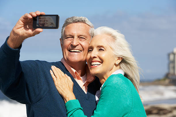 istock Senior Couple With Camera On Beach 160531809