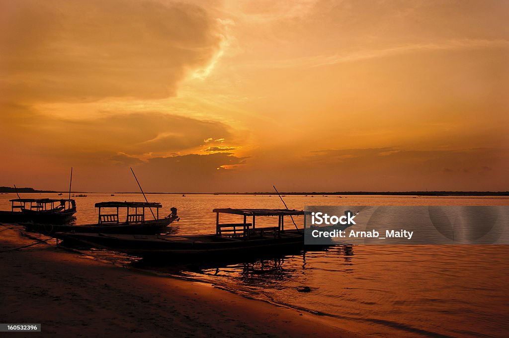 Chilika lake in Crimson Light Chilika Lake is the world's second largest lagoon, situated in Orissa, India. The crimson light in the dusk adds a new dimension to the beautiful lake Odisha Stock Photo