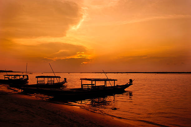 Chilika lake in Crimson Light Chilika Lake is the world's second largest lagoon, situated in Orissa, India. The crimson light in the dusk adds a new dimension to the beautiful lake Odisha stock pictures, royalty-free photos & images