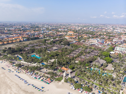 Beach in Bali, Indonesia. Badung City. Ocean Water and Palm Trees in Background. Popular Spot Among Tourists