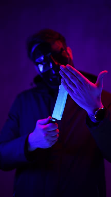 Scary Man Wearing A Black Mask And Holding A Knife