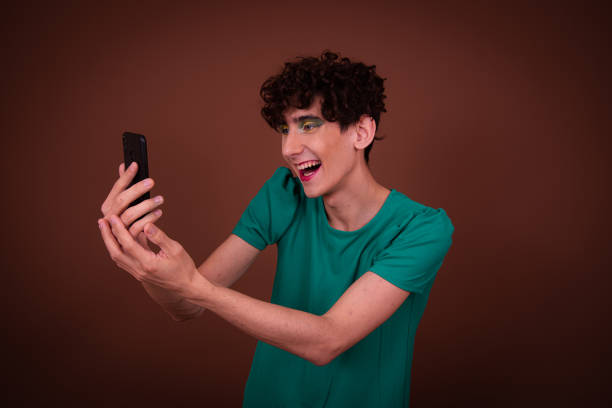 istock Funny drag queen posing in the studio on a brown background. 1605336162