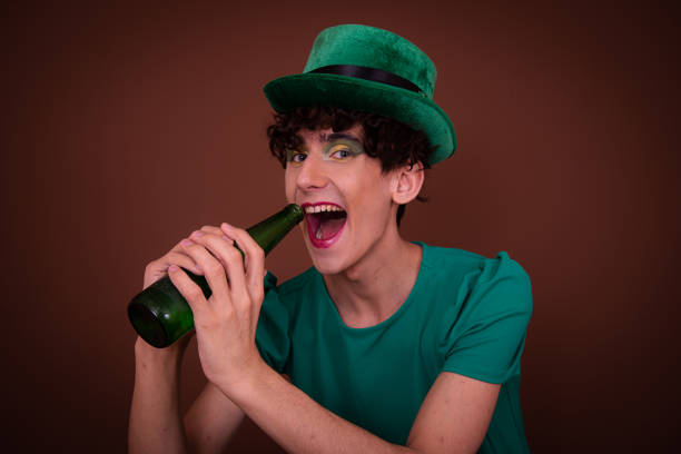 istock Drag Queen on St. Patrick's Day in a green hat drinks green beer. 1605338468