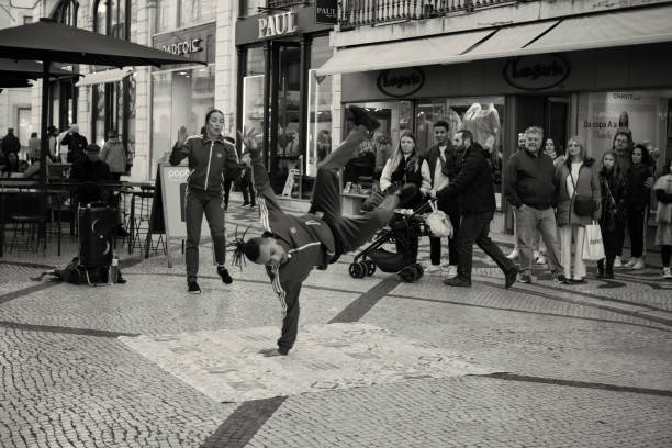 Lisbon, Portugal - January 15, 2023: A couple performs hip-hop dancing at the Rua Augusta street in Lisbon downtown.