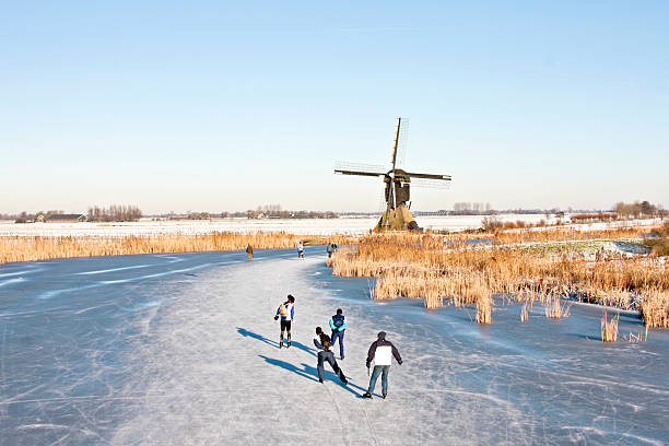 Ice skating on a frozen lake in the Netherlands stock photo
