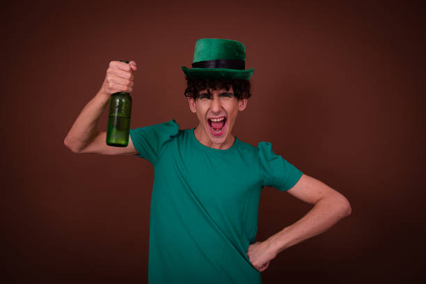 istock Drag Queen on St. Patrick's Day in a green hat drinks green beer. 1605347554