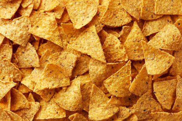 istock Tortilla chips on a gray background viewed from above. Mexican fast food. Top view. Full frame 1605350673