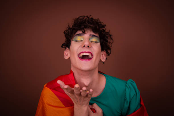 istock Funny drag queen posing in the studio on a brown background. 1605353729