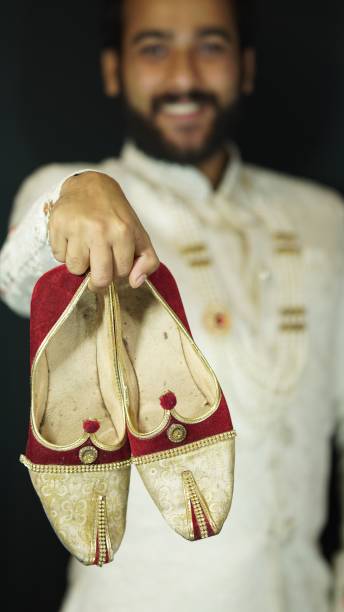 istock groom showing shoes indian wedding image 1605358404