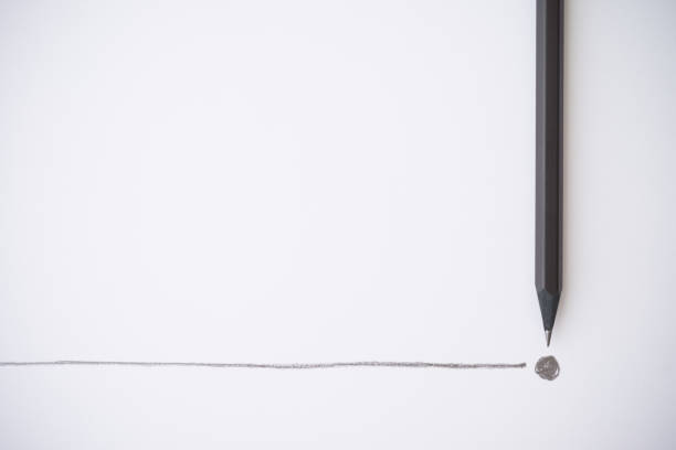 istock Flat lay of black color pencil write line and end point on white paper background. 1605369431