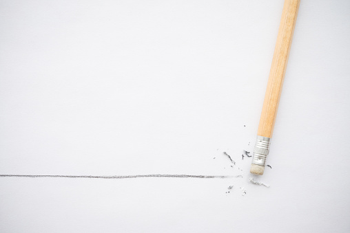 Flat lay of pencil eraser delete black line pencil on white paper background copy space. Repair, remove, creative idea, imagination and education concept.