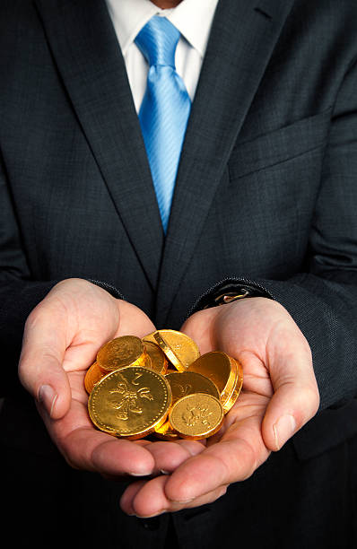 istock Handful of gold coins 160537128