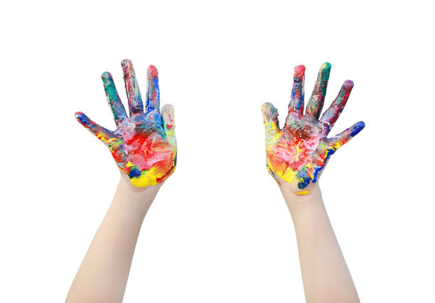 istock Close up kid hands painted in colorful paints isolated over white background. 1605375171