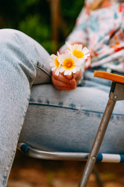 Woman Holding Flower in Her Hand