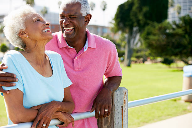 istock Senior couple standing together at a fence post 160537978