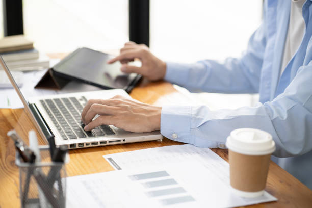 istock Business man working by using laptop computer Hands typing on a keyboard. Professional investor working new start up project. business planning in office. Technology business Concept. 1605380674
