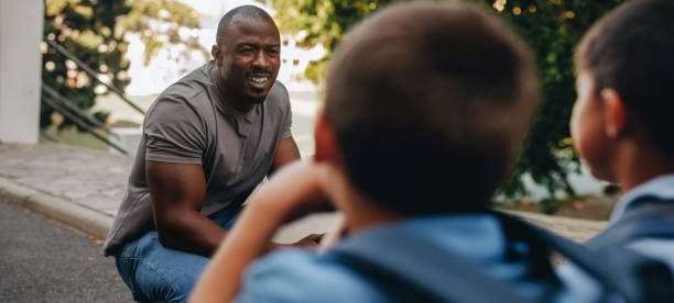 istock Teacher giving his students a pep talk in elementary school 1605390949