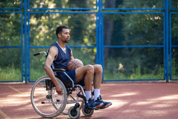 istock Basketball player in wheelchair on open gaming ground. 1605395564