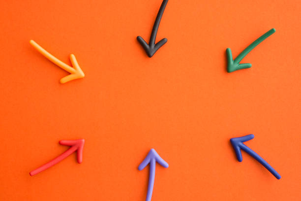 istock Color highlight arrows put around on orange background with copy space. 1605396112