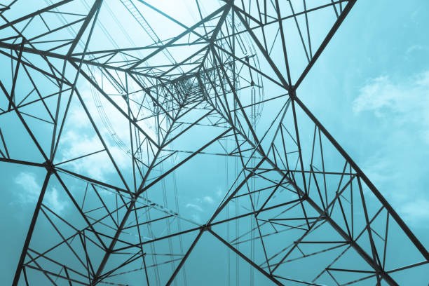 istock Abstract pattern from bottom view of high voltage pole power transmission tower. 1605399141