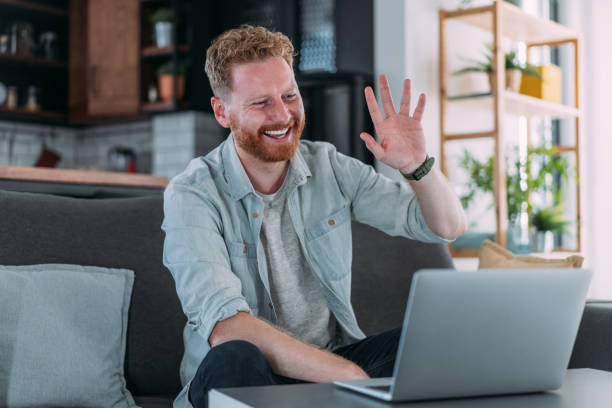 istock Man having video call at home. 1605404082
