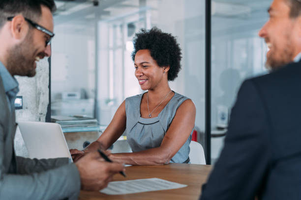istock Group of business persons talking in the office. 1605405739