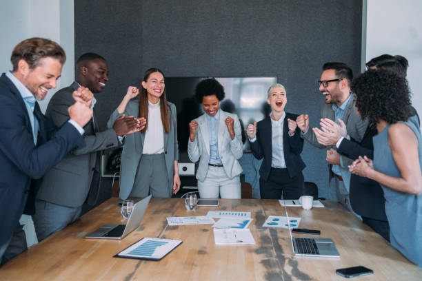 istock Cheerful entrepreneurs celebrating success in the office. 1605405772