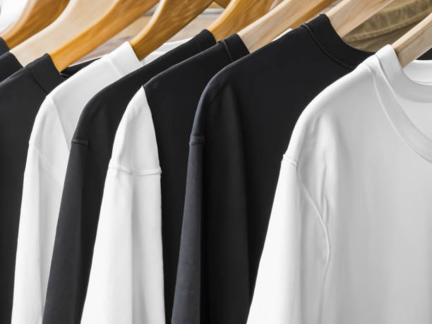 istock Realistic tshirt mockup | Blank black and white t-shirt on hanger, design mockup. Clear plain cotton tshirt mock up template. Apparel store logo mock branding display 1605406345