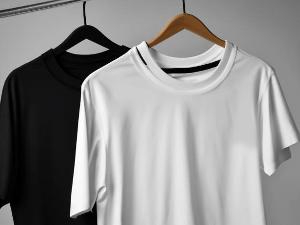 istock Realistic tshirt mockup | Blank black and white t-shirt on hanger, design mockup. Clear plain cotton tshirt mock up template. Apparel store logo mock branding display 1605407505