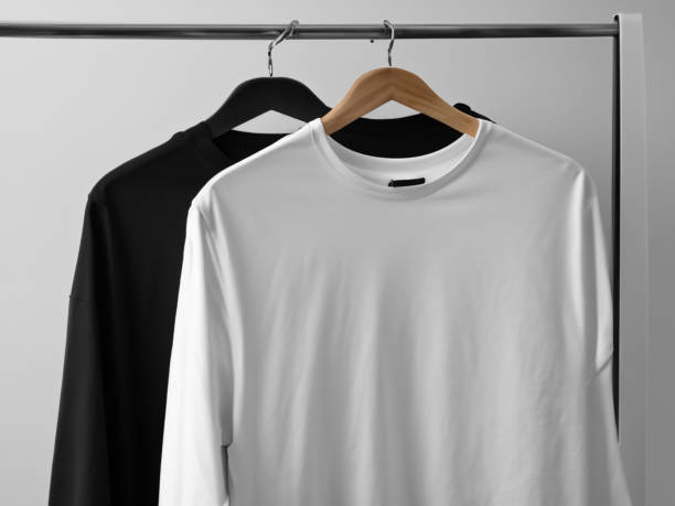 istock Realistic tshirt mockup | Blank black and white t-shirt on hanger, design mockup. Clear plain cotton tshirt mock up template. Apparel store logo mock branding display 1605408048