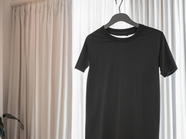 istock Realistic tshirt mockup | Blank black and white t-shirt on hanger, design mockup. Clear plain cotton tshirt mock up template. Apparel store logo mock branding display 1605411426