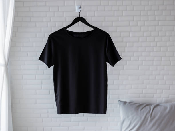 istock Realistic tshirt mockup | Blank black and white t-shirt on hanger, design mockup. Clear plain cotton tshirt mock up template. Apparel store logo mock branding display 1605411992