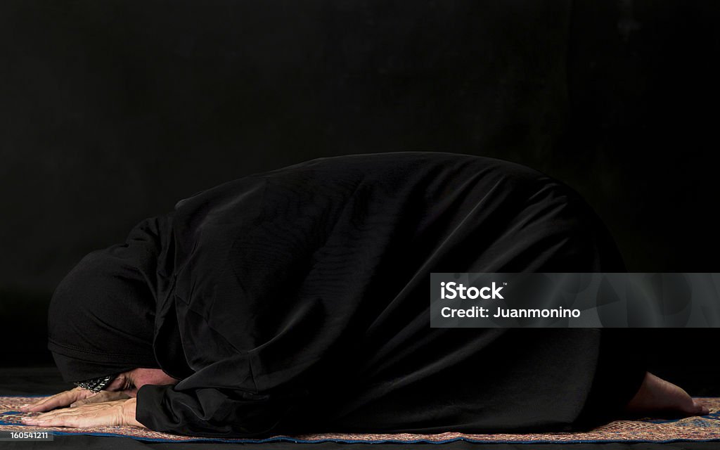 Ramadan Muslim woman  praying on black background (this picture have been shot with a Hasselblad HD3 II 31 megapixels) Khimaar Stock Photo