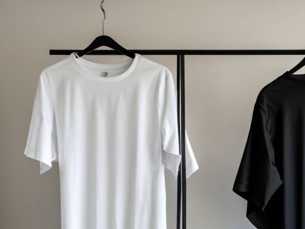 istock Realistic tshirt mockup | Blank black and white t-shirt on hanger, design mockup. Clear plain cotton tshirt mock up template. Apparel store logo mock branding display 1605412545
