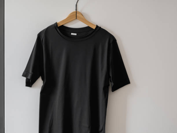 istock Realistic tshirt mockup | Blank black and white t-shirt on hanger, design mockup. Clear plain cotton tshirt mock up template. Apparel store logo mock branding display 1605413710